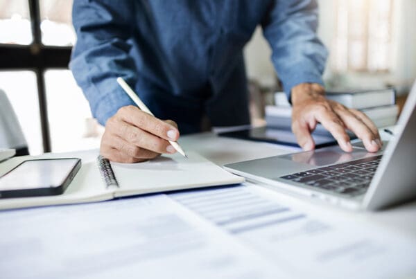 Guardian Custodian Conservator Bond - Close-Up Shot, Asian Businessman Take a Note and Working With Laptop at Office