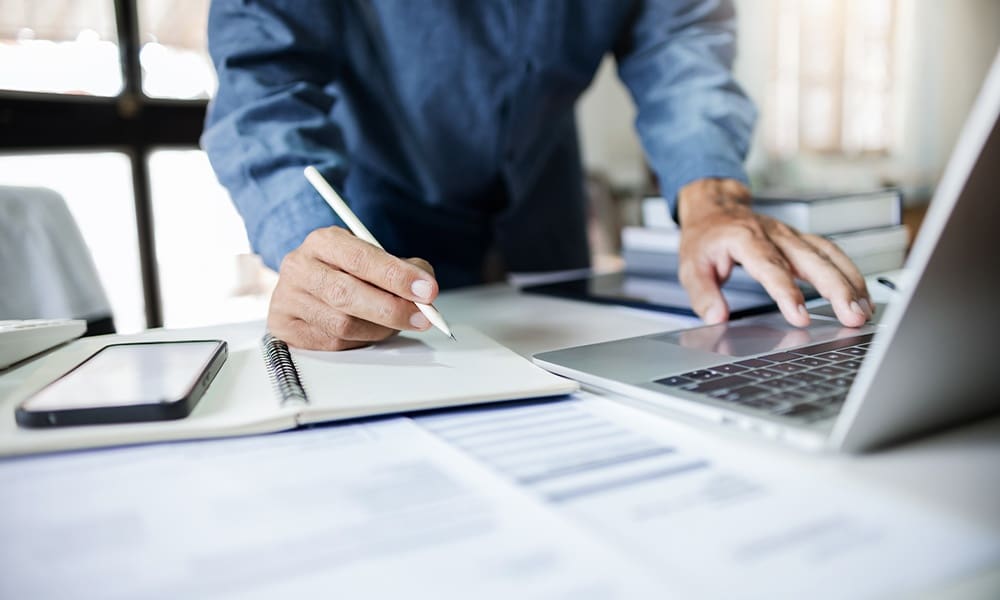 Guardian Custodian Conservator Bond - Close-Up Shot, Asian Businessman Take a Note and Working With Laptop at Office