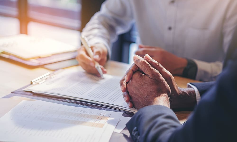 How to Obtain a Florida Financially Responsible Officer (Fro) Bond - Businessman Reading Documents at Meeting, Business Partner Considering Contract Terms Before Signing Checking Lega